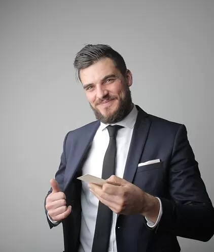 Business man in suit handing out a business card